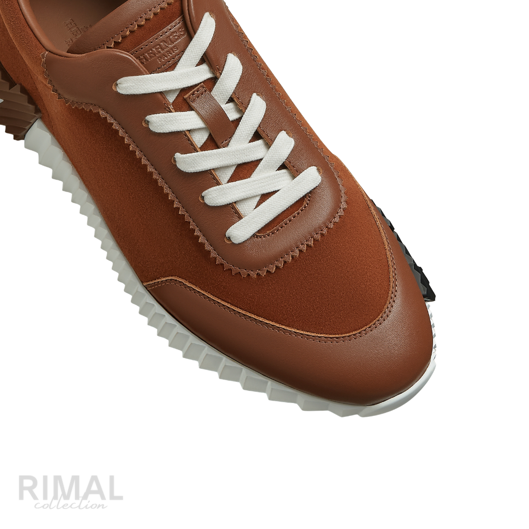 Hermès Bouncing Sneakers in gold, crafted from soft suede and calfskin with a distinctive ridged white rubber sole