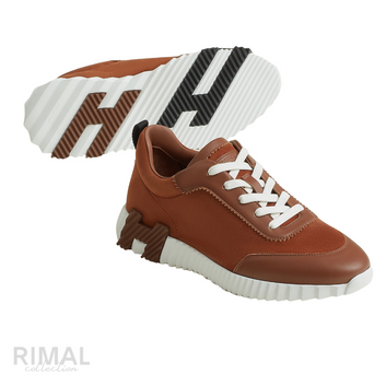 Hermès Bouncing Sneakers in gold, crafted from soft suede and calfskin with a distinctive ridged white rubber sole