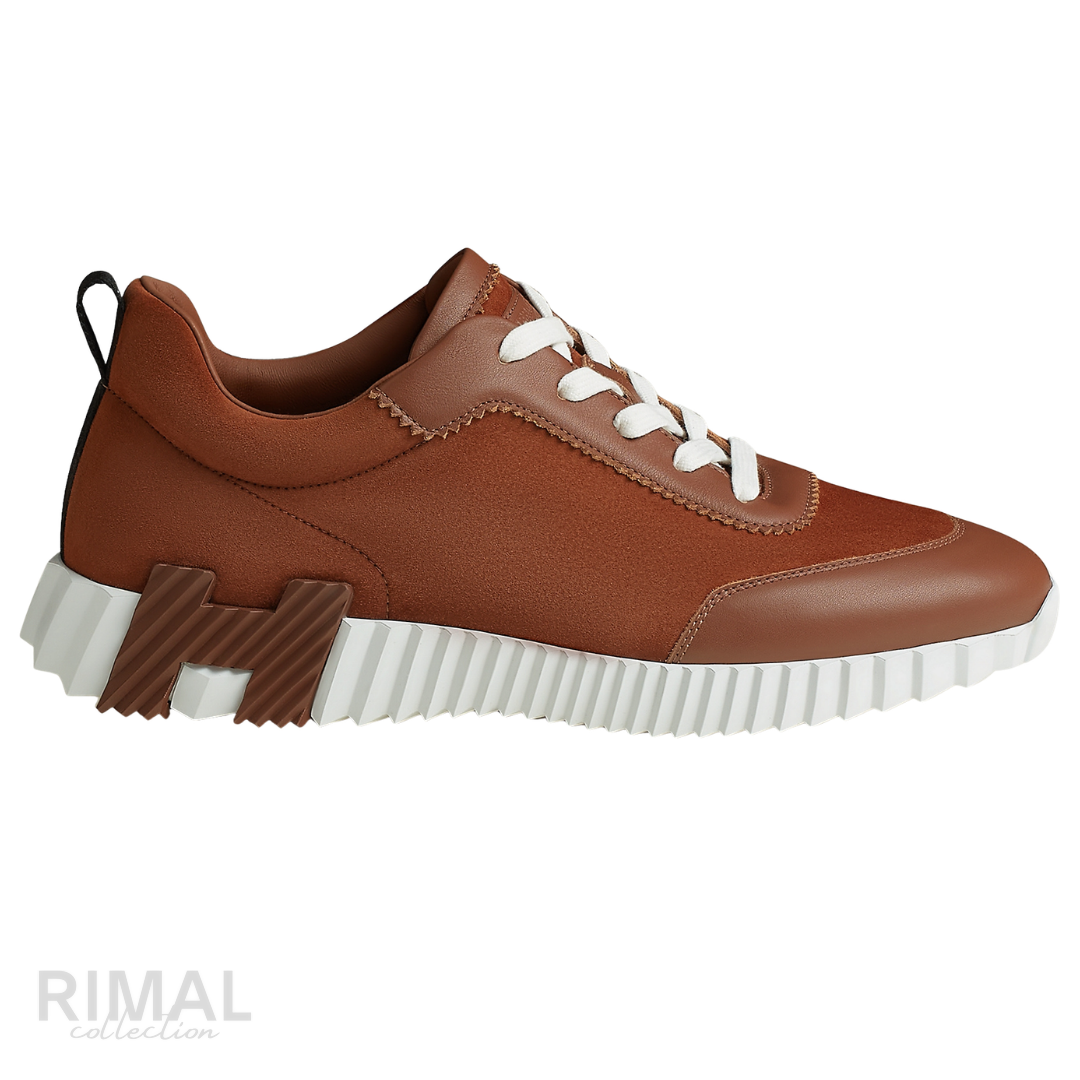 Hermès Bouncing Sneakers in gold, crafted from soft suede and calfskin with a distinctive ridged white rubber sole