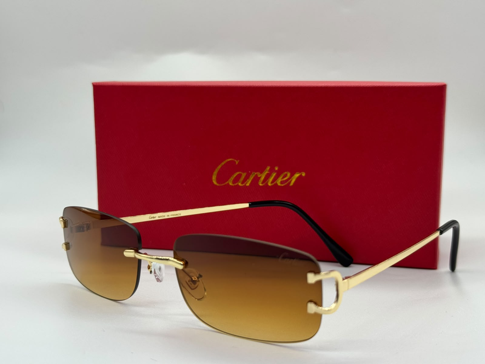 Cartier | Panthère de Cartier Rimless Rectangular Sunglasses – Gold / Light Pink – Product Image 1